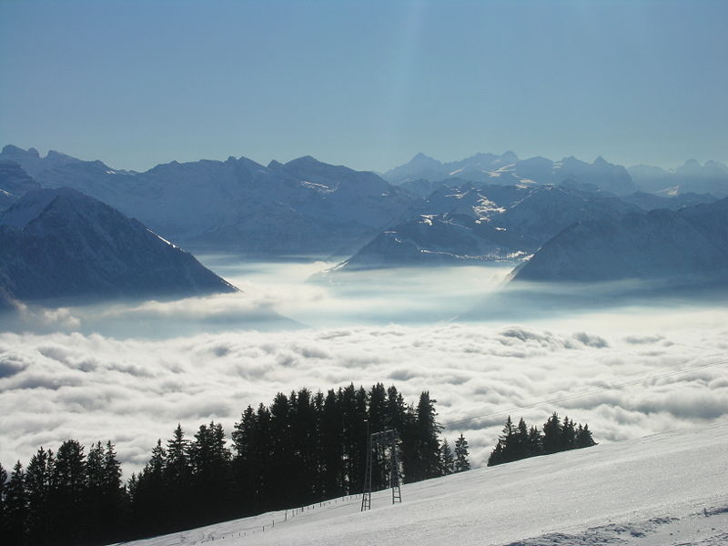 This amazing photo shows a thick blanket of fog resting amongst the mountains. Taken from high above, this photo looks down on the fog, creating a unique image with the mountains just managing to pierce the surface of the fog.